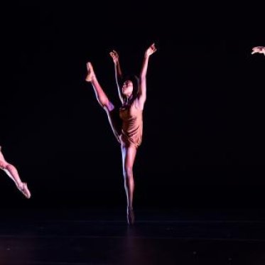 Three dancers occupying each third of the frame, each doing a different pose