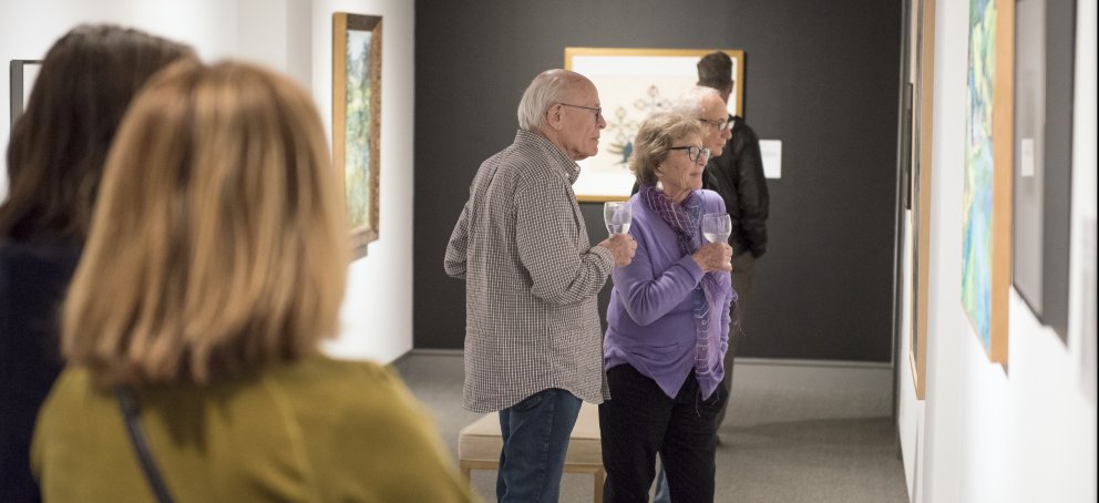 visitors in the galleries looking at art