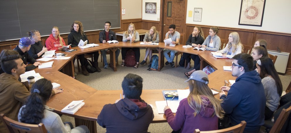 Students in a seminar class, sitting around a circular table