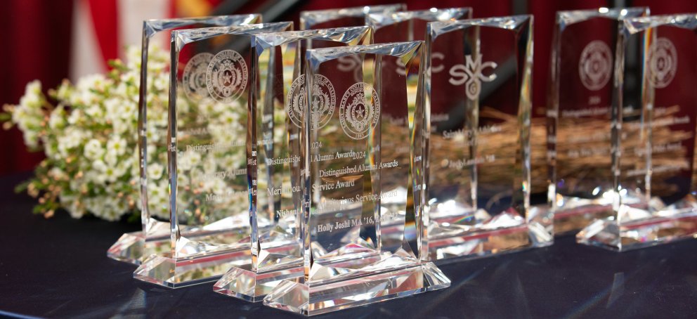 Glass trophies with white flowers at the Alumni Awards Ceremony